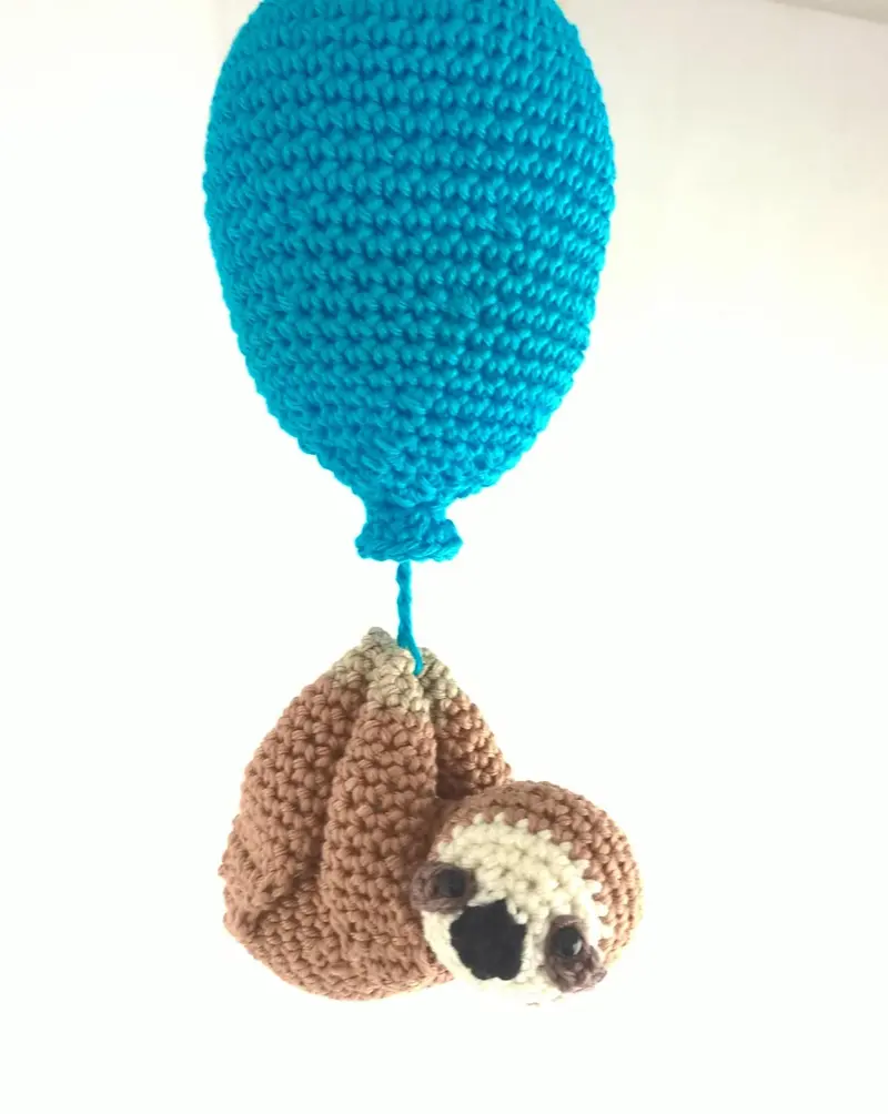 Crochet sloth with balloon