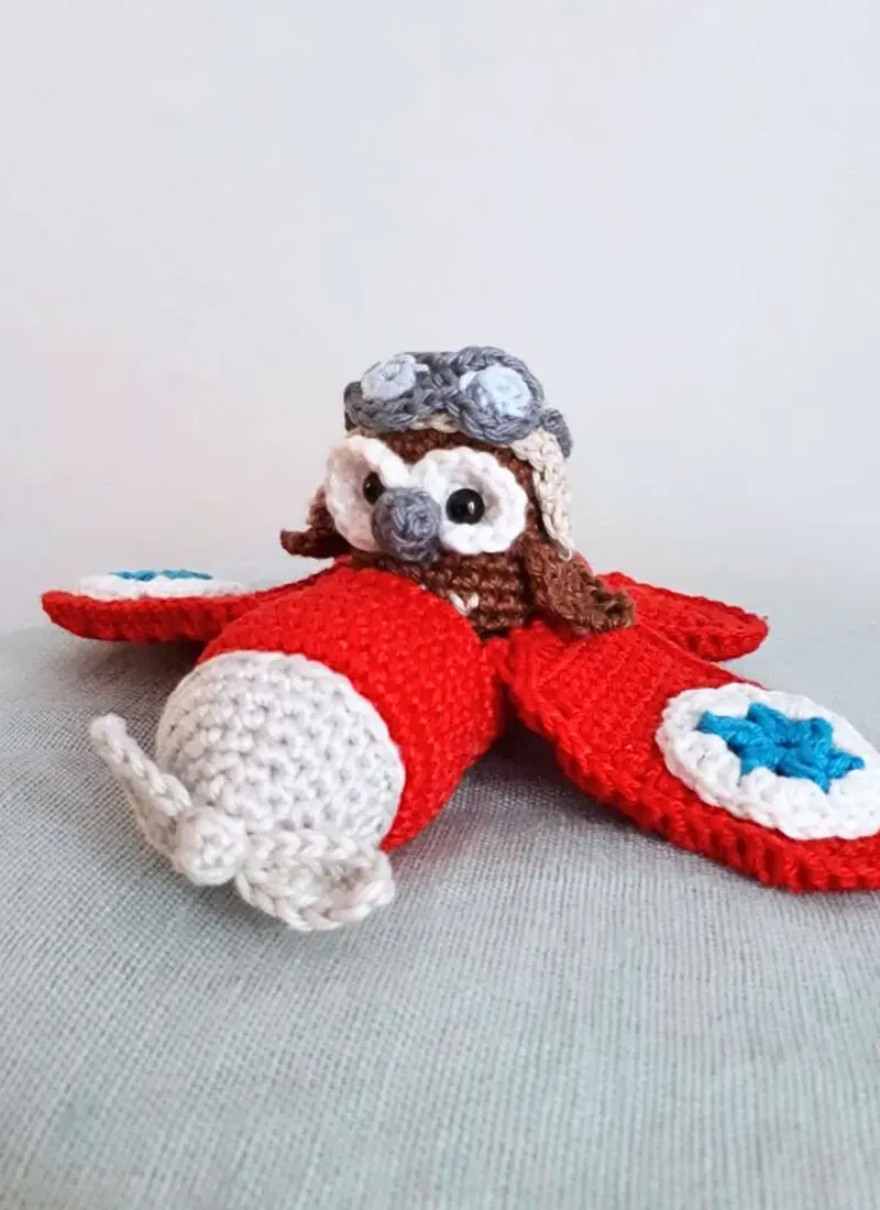 Red airplane with owl stuffed toy